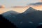 Snowcap mountains against colorful sunset sky background