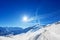 Snowcapped alpine path with anti avalanche barrier