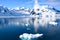 Snowcapped mountains in beautiful landscape reflecting in blue water, ice flows, Lemaire Channel near Paradise Bay, Antarctica