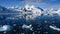 Snowcapped mountains in beautiful landscape, reflecting in blue water, ice flows, Lemaire Channel near Paradise Bay, Antarctica