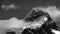 snowcapped peak of Cerro Paine Grande with clouds, monochrome