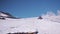Snowcat caterpillar machine with passangers rides on mountain steep