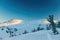 Snowcat tracks on a ridge covered with fir trees in Sheregesh in winter