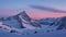 A snowcovered mountain range stretches as far as the eye can see