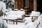 snowcovered patio furniture outside chalet