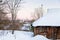 Snowcovered wooden house in country