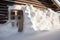 snowdrift blocking a rustic wooden cabin door