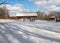 A snowed covered rest area wood pavilion in a hiking trail winter.