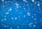 Snowfall Christmas background. Flying snow flakes and stars on winter blue sky background. Winter wite snowflake template. Vector