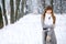 Snowfall in the forest, the girl smiles and poses, a beautiful winter, a great New Year mood