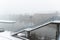 Snowfall over the Main river in Schweinfurt with a bridge stairs