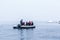 Snowfall over the Zodiac boat with frozen polar divers near Almirante Brown, Antarctic peninsula