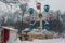 Snowfall in Tallinn. Children`s Ferris wheel in a snow-covered park. Estonia