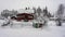 Snowfall in the village. Blurred background. Old wooden house in the snow. Traditional typical Scandinavian Swedish house or villa