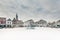 Snowfall on a winter day on the central square with ancient buildings in the Dutch city of Amersfoort, The Netherlands