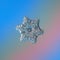 Snowflake glittering on blue gradient background