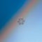 Snowflake glittering on blue gradient background