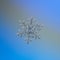 Snowflake glittering on light blue background