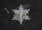Snowflake shining crystal star at black background