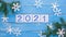 Snowflakes on blue wooden background with 2021 over white background - represents the new year 2021 , stop motion
