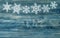 Snowflakes border over rustic wooden background. winter holidays