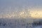 Snowflakes on a glass window on a winter.