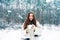 Snowing winter beauty fashion concept. Women in winter clothes. Outdoor close up portrait of young beautiful girl with