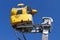 Snowmaking on blue background. Yellow Snow cannon in Carpathian Mountains, Romania