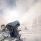 Snowmaking machine snow cannon or gun in action