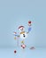 Snowman with Christmas decorations balancing on gift boxes and star.