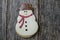 Snowman Cookie on Rustic Wood Background