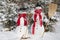 Snowman couple in winter - christmas outdoor decoration with snow