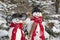 Snowman couple in winter - christmas outdoor decoration with snow