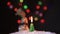 The snowman dances a round dance around a Christmas fir-tree against the background of colourful fires