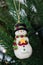 Snowman decoration hanging from tree