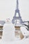 Snowman and Eiffel tower on a day with heavy snow