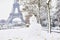Snowman and Eiffel tower on a day with heavy snow