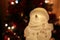 Snowman among festive lights