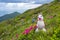 Snowman with a flower on a blooming alpine meadow