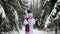 Snowman with gifts. Gifts for Christmas and New Year.Snowman plays with a red gift box in the winter snowy forest