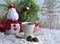 Snowman handmade, cup of coffee and candy on a snowy forest background