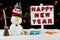 Snowman with a Happy New Year signpost