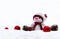 Snowman knitted handmade, pine cones, christmas red balls on snow with space for text. Christmas decoration