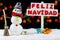 Snowman with a Merry Christmas signpost written on spanish