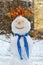 Snowman portrait in a city street, winter season, snowy weather