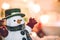 Snowman stand among pile of snow at silent night, light up the hopefulness and happiness in Merry christmas and