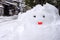 Snowman statue making from snow in winter day
