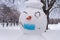 Snowman wearing a protective mask during Covid-19 pandemic