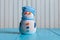 Snowman wearing striped sweater on blue wooden