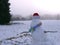 Snowman after winter snowfall wearing hat and scarf